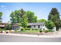 Well-maintained home with lush landscaping, a new garage door, and a inviting curb appeal at 2998 S Adams St, Denver, CO 80210