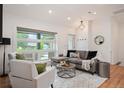 Cozy living room featuring hardwood floors, large windows, and comfortable seating at 2998 S Adams St, Denver, CO 80210