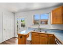 Galley kitchen featuring wood cabinets, laminate counters, and stainless steel appliances at 16215 E Brunswick Dr, Aurora, CO 80013