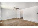 View of living room featuring neutral walls, carpet, and ceiling fan at 16215 E Brunswick Dr, Aurora, CO 80013