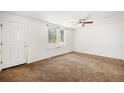 View of living room featuring carpet, a large window, and white walls at 16215 E Brunswick Dr, Aurora, CO 80013