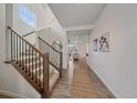 Inviting entryway featuring wood floors, staircase with iron spindles, and an open view of the living area at 8268 Mt Harvard Rd, Littleton, CO 80125