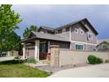 Charming two-story home with a three car garage, fence and a well-manicured front lawn at 9616 Nucla St, Commerce City, CO 80022
