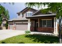 Charming two-story home with a three car garage and a well-manicured front lawn at 9616 Nucla St, Commerce City, CO 80022