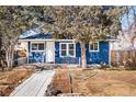 Quaint blue home featuring a cozy front porch, mature tree, and a well-kept yard at 1195 Florence St, Aurora, CO 80010