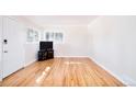 Bright living room featuring refinished hardwood floors, fresh neutral paint, and new double pane windows at 1195 Florence St, Aurora, CO 80010