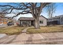 Charming home exterior with mature tree, inviting front porch, and well-maintained landscaping at 3200 S Logan St, Englewood, CO 80113