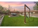 Expansive backyard featuring a covered patio area with outdoor seating and a relaxing hammock at 11896 W 107Th Ave, Westminster, CO 80021