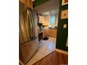 Functional kitchen with modern stainless steel refrigerator and natural wood cabinetry at 1024 E 14Th Ave # 2, Denver, CO 80218