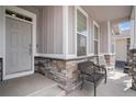 Charming front porch featuring stone accents and comfortable seating at 8852 Farmdale St, Firestone, CO 80504