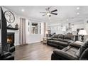 Bright living room with fireplace and hardwood floors flowing into the dining area at 8852 Farmdale St, Firestone, CO 80504