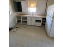 Simple kitchen with white cabinets, vintage countertops, and a refrigerator at 1368 Joliet St, Aurora, CO 80010