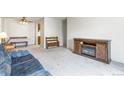 Open-concept living area featuring fireplace, neutral carpet, and bright light at 3550 S Harlan St # 214, Denver, CO 80235