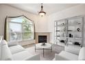 Cozy living area featuring a fireplace, bright window, and ample space for relaxing and entertaining at 1878 S Cole St, Lakewood, CO 80228
