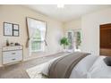A bright main bedroom with a large window, neutral tones and access to a private balcony at 1878 S Cole St, Lakewood, CO 80228