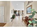 Spacious foyer with tiled floor, bench, and views into the dining area at 10145 Joseph Dr, Highlands Ranch, CO 80130
