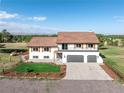 Beautiful exterior of a two-story home boasting a three-car garage and pristine landscaping at 10694 Camelot Dr, Franktown, CO 80116