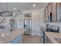 Contemporary kitchen with granite countertops, stainless steel appliances and convenient access to dining area at 17910 E 54Th Ave, Denver, CO 80249