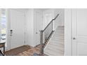 Bright entryway featuring wood floors, a staircase, and a welcoming atmosphere for guests at 8353 Bijou Creek Ave, Littleton, CO 80125