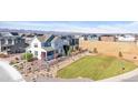 New construction home with a welcoming front yard in a community surrounded by mountain views at 8353 Bijou Creek Ave, Littleton, CO 80125
