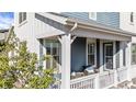 Inviting covered front porch featuring outdoor seating, stylish trim, and a cozy spot to relax and enjoy the outdoors at 8353 Bijou Creek Ave, Littleton, CO 80125