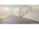 Neutral living area with stairs to the upper level, next to the front door at 360 Upham St, Lakewood, CO 80226