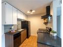 This kitchen includes wooden cabinets, sleek countertops, and modern appliances at 3100 S Federal Blvd # 307, Denver, CO 80236