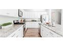 Bright kitchen features stainless steel appliances, granite countertops, and a large center island at 17850 W 94Th Dr, Arvada, CO 80007