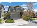 Two-story home featuring stone accents, a well-manicured lawn and a two-car garage at 5400 Heatherton Ln, Highlands Ranch, CO 80130