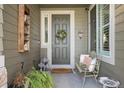 Inviting front entry features a cozy sitting area with stylish decor and a 'Welcome Home' doormat at 5400 Heatherton Ln, Highlands Ranch, CO 80130