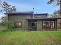 Charming two-story home with wood siding and well-maintained front yard surrounded by mature trees at 26765 Bradley St, Conifer, CO 80433