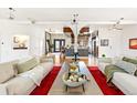Spacious living room with an open layout, hardwood floors, and access to the kitchen at 4730 W Moncrieff Pl, Denver, CO 80212