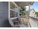 Inviting covered porch with seating offers a cozy outdoor relaxation space and neighborhood views at 10295 Ravenswood Ln, Highlands Ranch, CO 80130