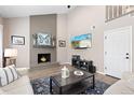Cozy living room with a brick fireplace, high ceilings, and a comfortable seating arrangement at 6616 Zinnia St, Arvada, CO 80004