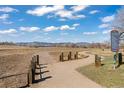 Scenic view of the open space with a walking trail and distant mountain views under a blue sky at 6616 Zinnia St, Arvada, CO 80004