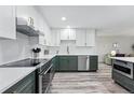 Modern kitchen with stainless steel appliances, custom cabinets, and quartz countertops at 13850 E Marina Dr # 606, Aurora, CO 80014