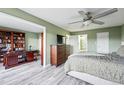 Spacious bedroom with hardwood floors, ceiling fan, and adjoining office space at 13850 E Marina Dr # 606, Aurora, CO 80014