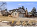 Two-story home with attached garage, neat landscaping and driveway on quiet street at 6323 W Rowland Cir, Littleton, CO 80128