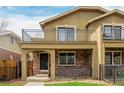Charming two-story home with brick accents, a balcony, and a cozy front porch at 1653 S Logan St, Denver, CO 80210