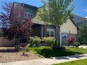 Attractive two-story home with well-manicured lawn and mature landscaping at 18090 E 47Th Dr, Denver, CO 80249