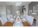 Formal dining room boasts a modern chandelier and staircase in view at 1586 S Goldbug Cir, Aurora, CO 80018