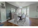 Elegant dining room with modern chandelier and seating for six at 1586 S Goldbug Cir, Aurora, CO 80018