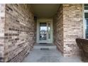 Charming front entrance with brick facade and a 'Blessed' door mat at 1586 S Goldbug Cir, Aurora, CO 80018