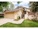 Unique two-story home with a two car garage, mature trees, and inviting curb appeal at 40 S Dexter St, Denver, CO 80246