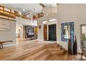 Spacious foyer featuring high ceilings, wood floors, and stairway at 5034 E Otero Cir, Centennial, CO 80122