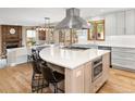 Spacious kitchen island features a large cooktop, seating, and stylish cabinetry at 5034 E Otero Cir, Centennial, CO 80122