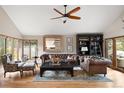 Cozy living room with vaulted ceilings, bay windows, and comfortable seating at 5034 E Otero Cir, Centennial, CO 80122