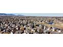 Panoramic aerial view of the neighborhood showcases homes and green spaces near the mountains at 6508 Moss Cir, Arvada, CO 80007