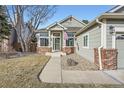 Well-maintained home showcasing a tidy front yard and brick-accented entrance with inviting curb appeal at 6508 Moss Cir, Arvada, CO 80007