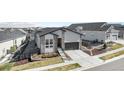 Beautiful home in a suburban neighborhood featuring stone accents, a two-car garage, and a well-manicured front yard at 7202 Canyonpoint Rd, Castle Pines, CO 80108